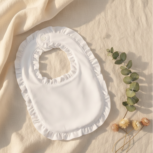 White frilly baby bib - aesthetic flat-lay